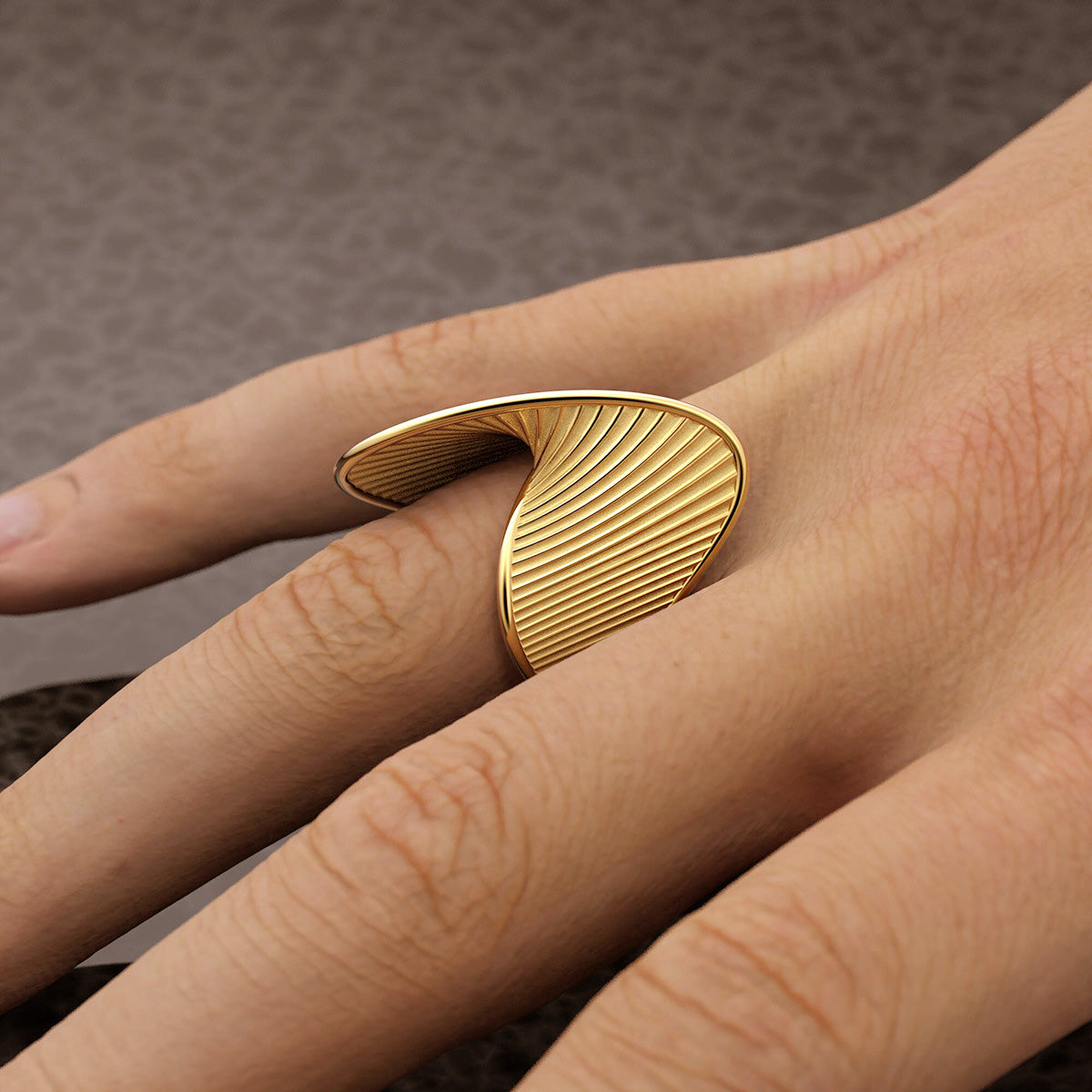 A uniquely curved and etched gold ring from the geometric set.