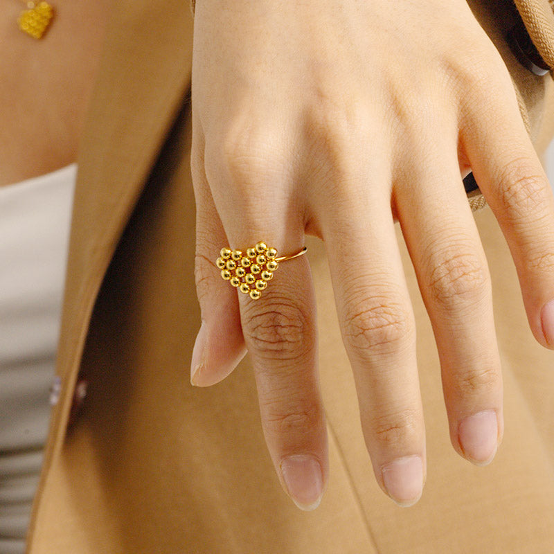 Detailed view of a gold bead ring with a flower design.