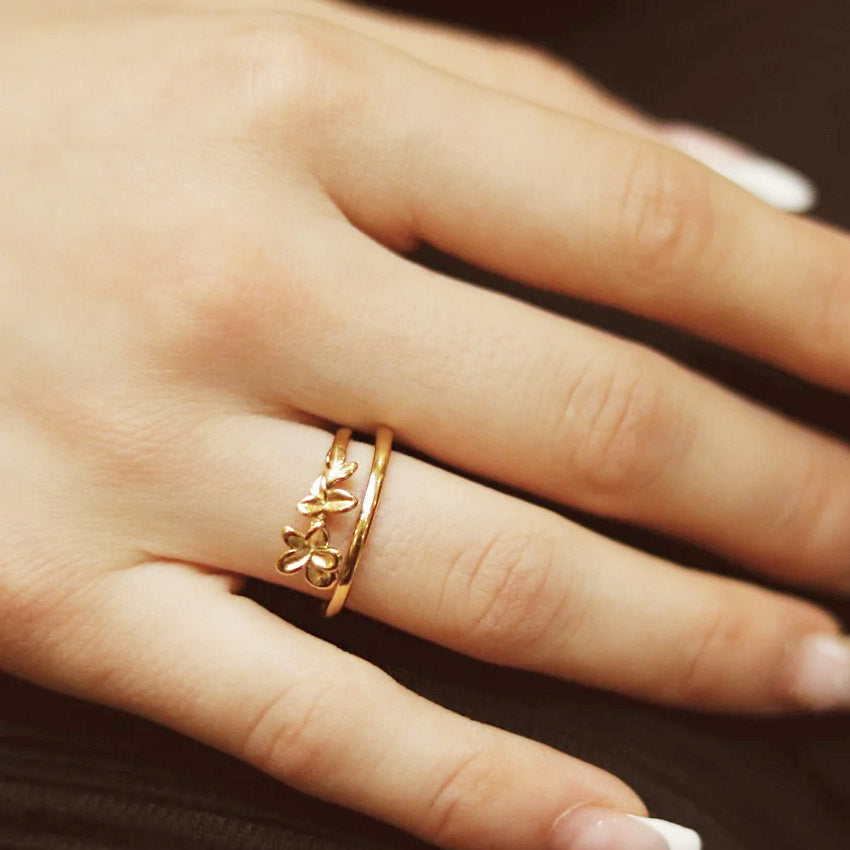A detailed view of the double-layer floral ring on a woman's hand.