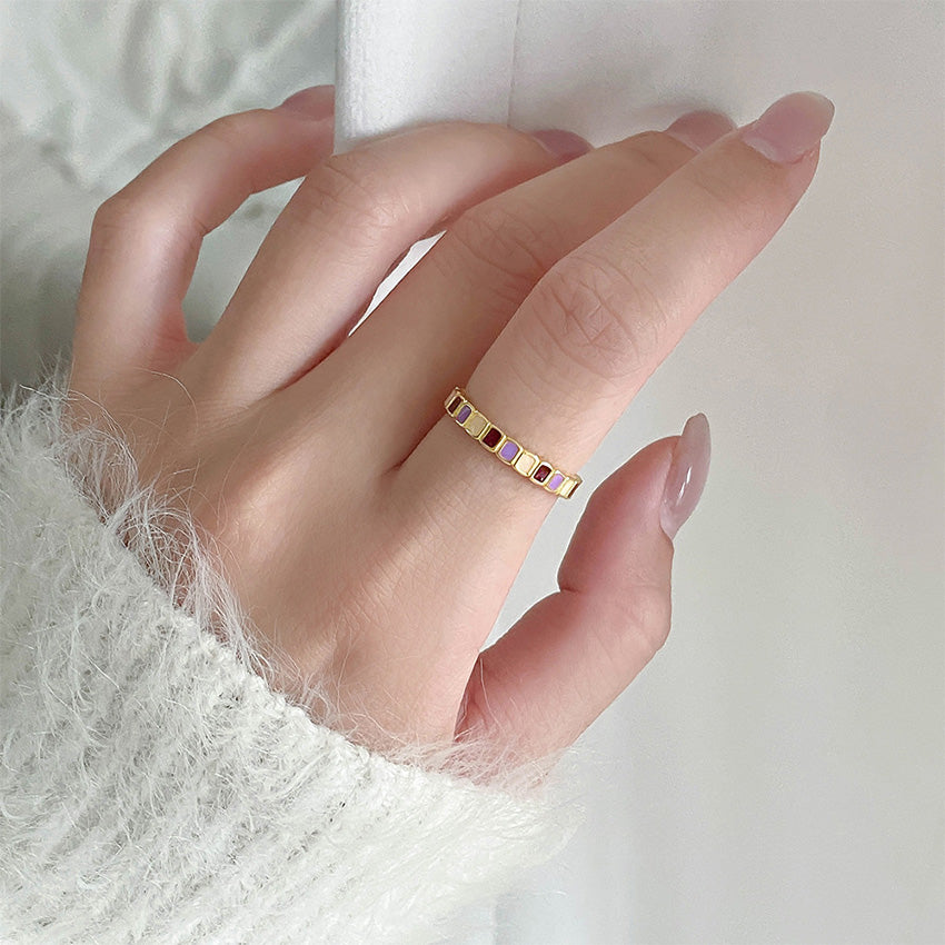 A model's hand showcasing the stylish fit of the adjustable color-block enamel ring.
