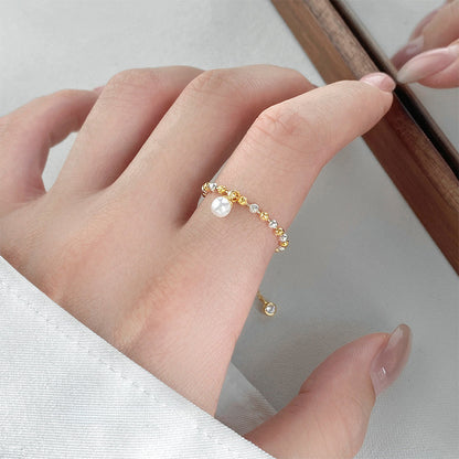 Detailed view of the two-tone beaded pearl adjustable ring design.