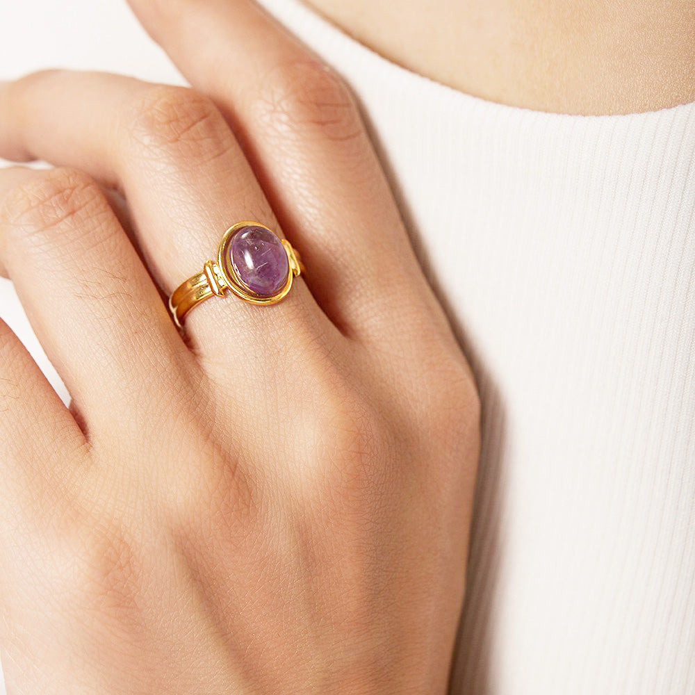 A model wearing the stainless steel amethyst cabochon open ring