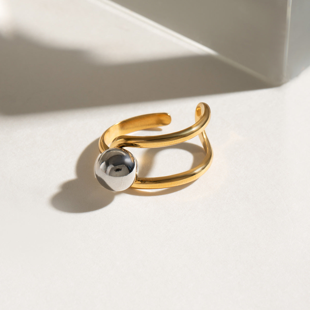 Close-up of the two-tone gold and silver ball on the adjustable open ring