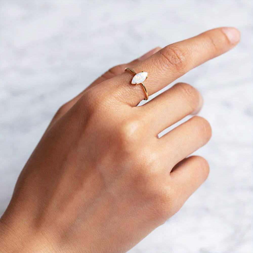 A model wearing the 925 sterling silver stackable opal ring set to showcase its versatile style.