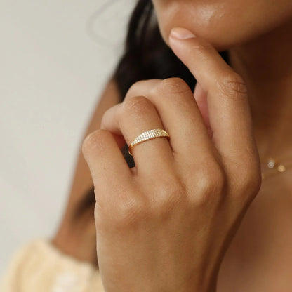 A close-up of the gold plated CZ signet ring on a woman's hand.