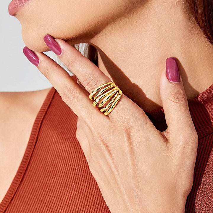 A woman wearing a gold multi-layered cuff ring from the vintage set.