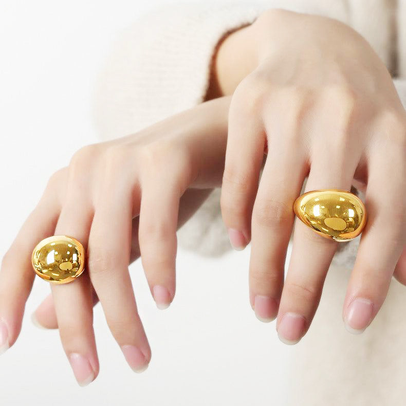 A close-up of the gold chunky drop-dripping rings showcasing their unique texture.