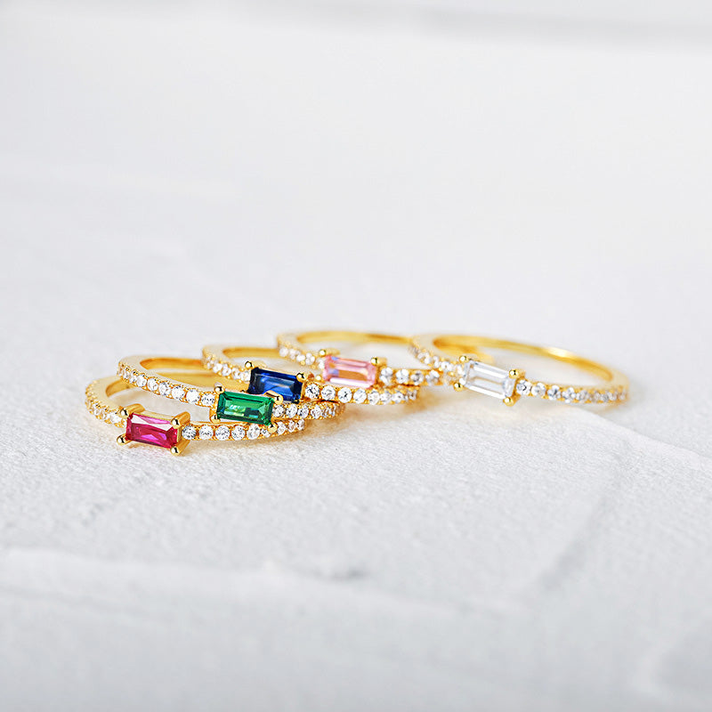 A set of gold-plated sterling silver rings with vibrant baguette-cut zircon gemstones.