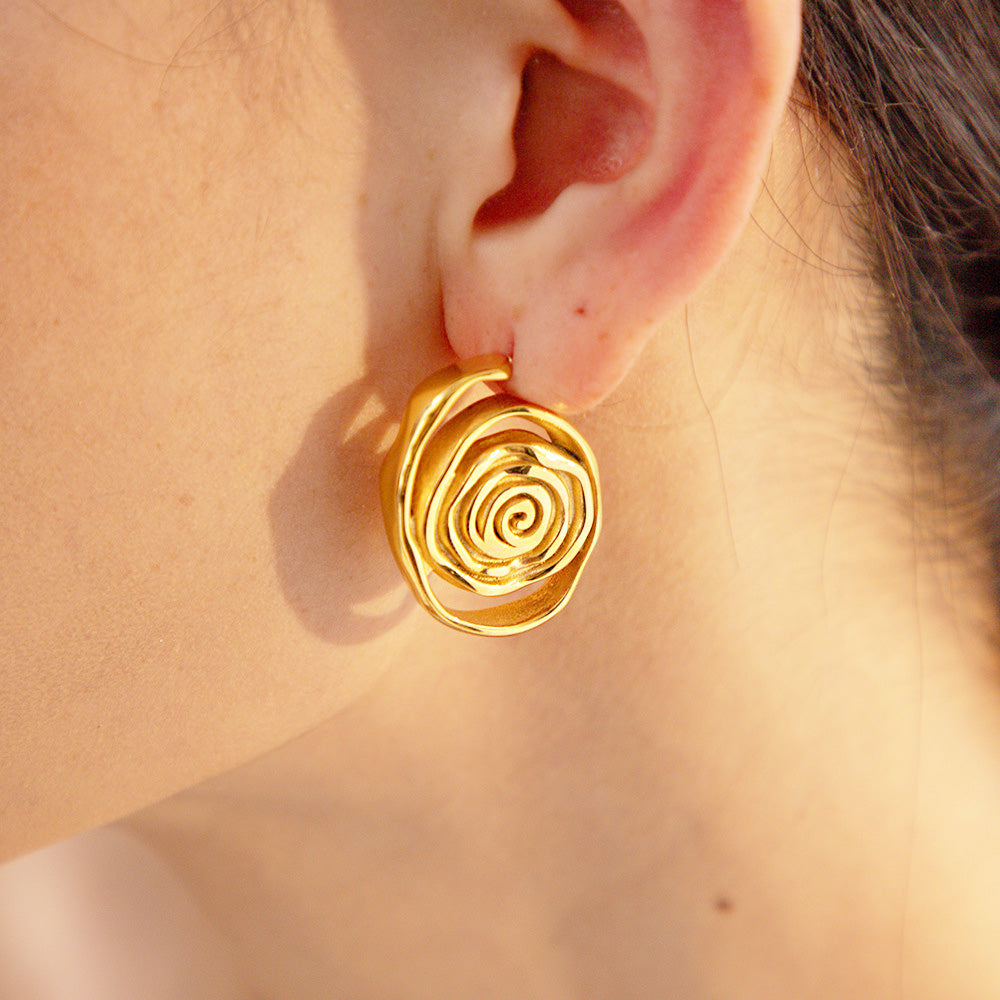 Model wearing the gold spiral stainless steel stud earring