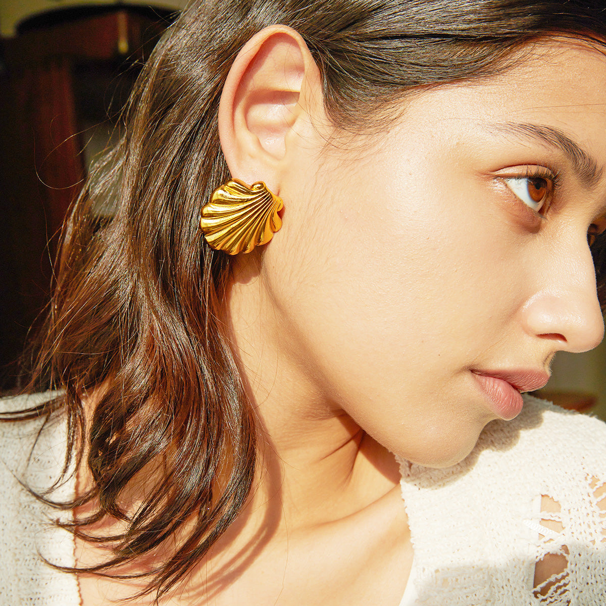 Model wearing the gold scallop shell stainless steel earring
