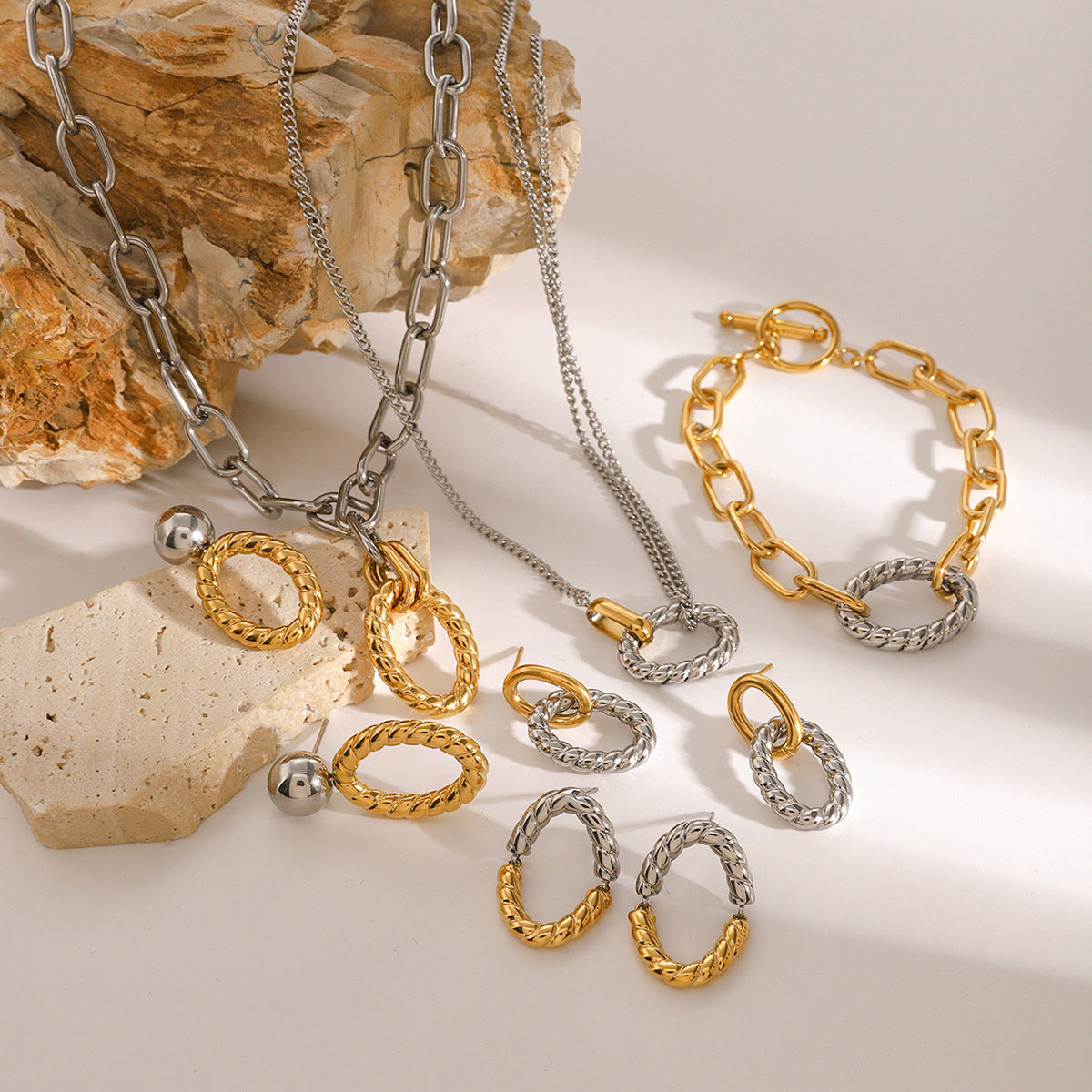 A complete jewelry set featuring the two-tone earrings with a matching necklace and bracelet.
