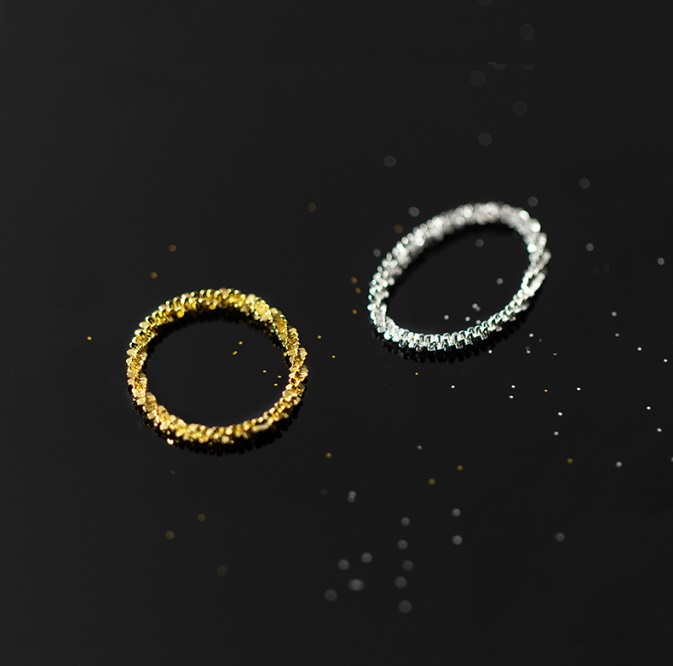 Detailed view of the silver and gold minimalist chain rings