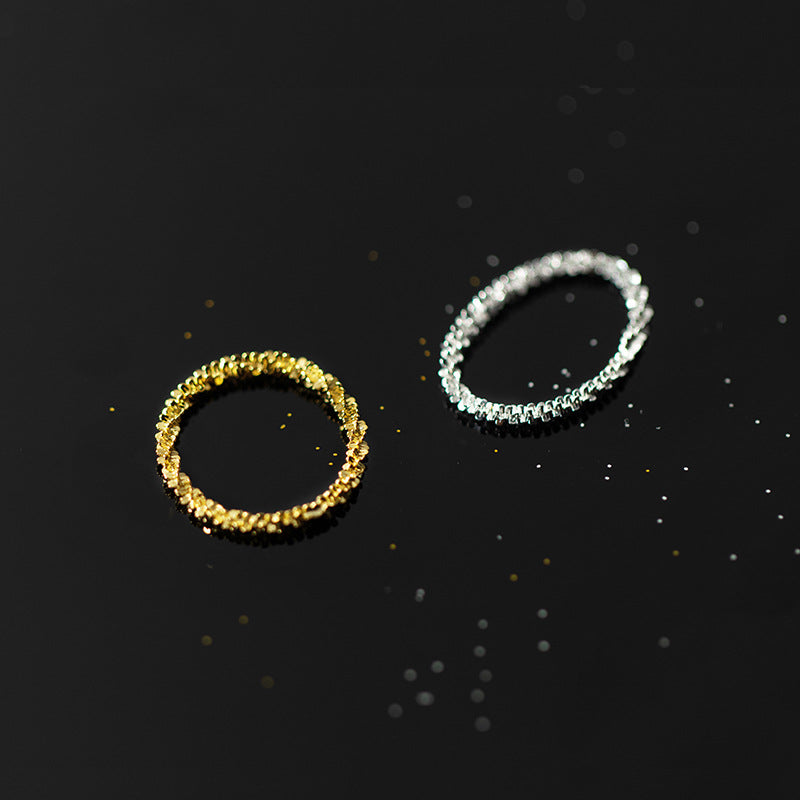 Detailed view of the textured gold and silver rings