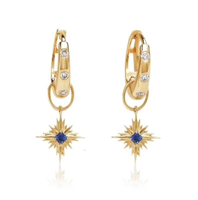 Gold starburst earrings with blue gemstones showcasing the changeable design