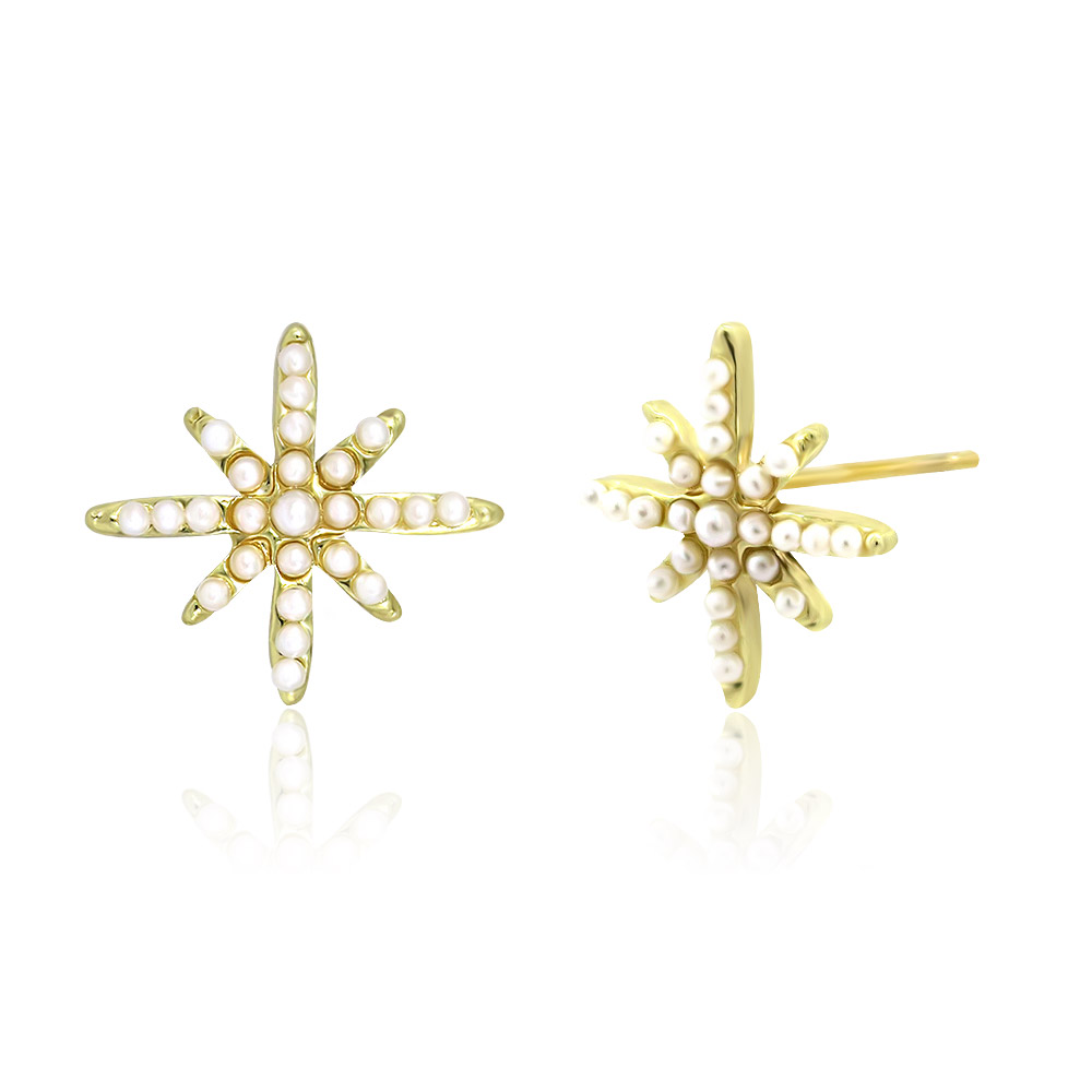 A detailed view of the gold starburst pearl earring, highlighting the intricate pearl settings.