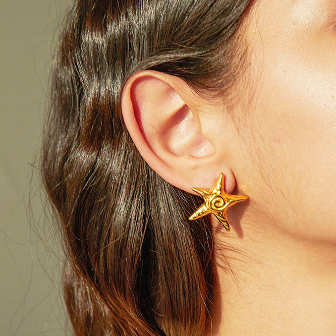 A model wearing the waterproof 18K gold plated star stud earring