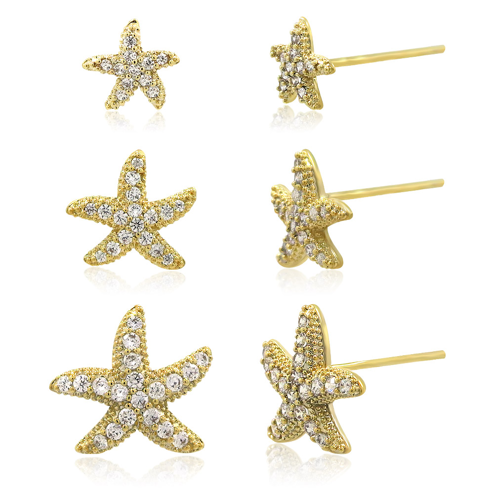 A detailed view of the three pairs of gold starfish earrings