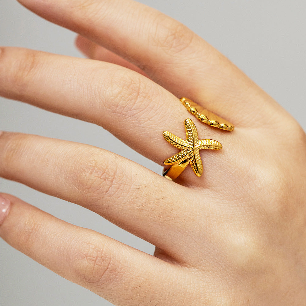 A model wearing the gold starfish stainless steel ring
