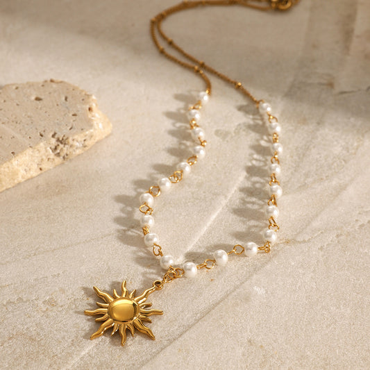 Dainty gold sun pendant necklace with a pearl chain, showcasing waterproof stainless steel jewelry
