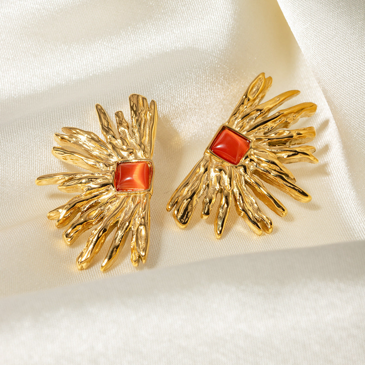 Close-up of the red gemstone fan-shaped earring
