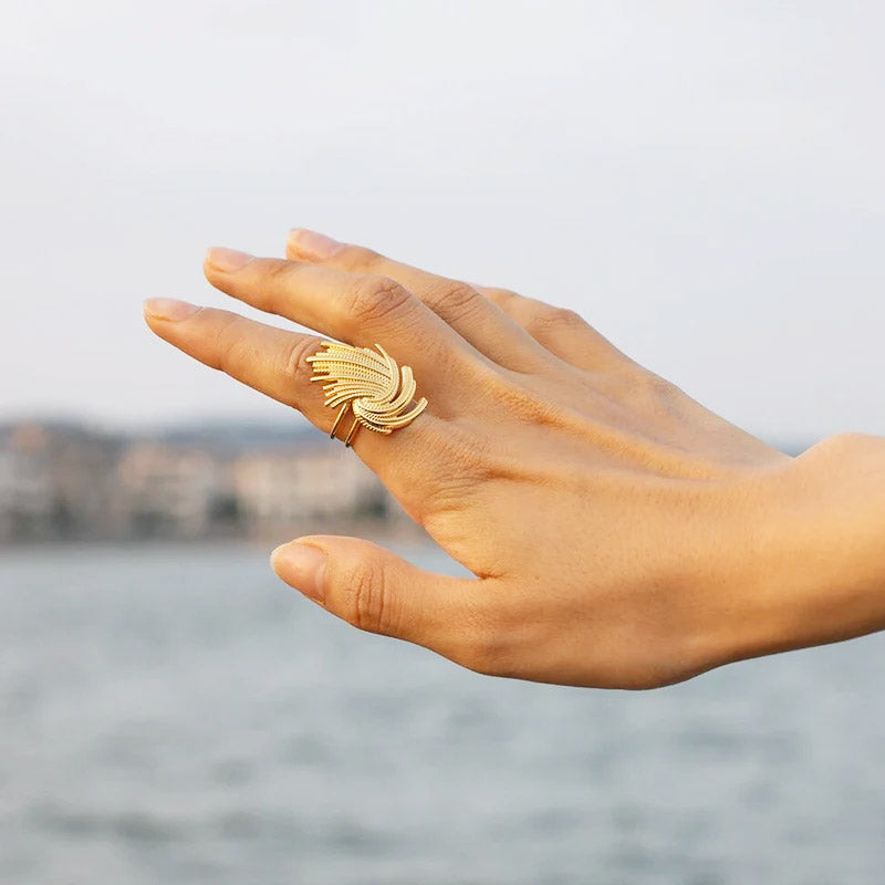 A model's hand showcasing the elegant gold vintage weave adjustable ring