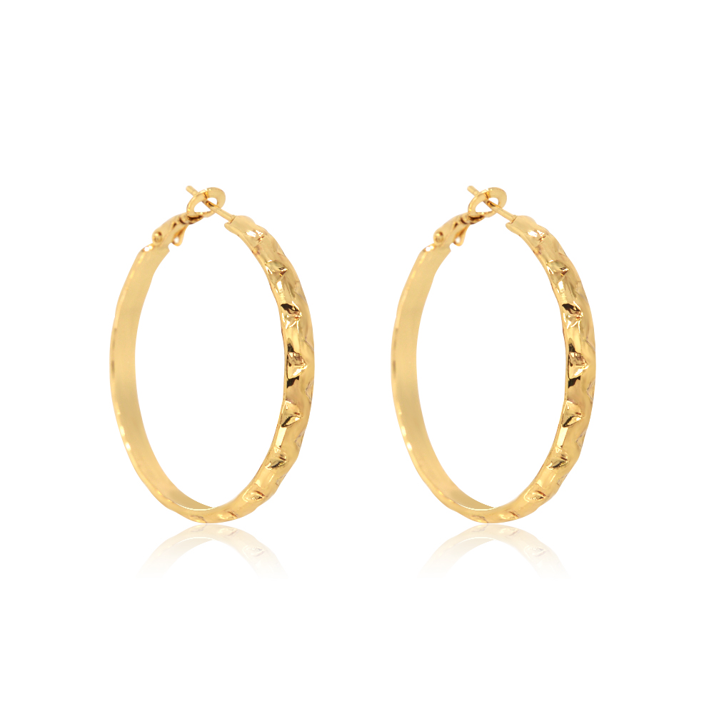 Detailed view of the diamond-cut texture on the gold hoop earrings