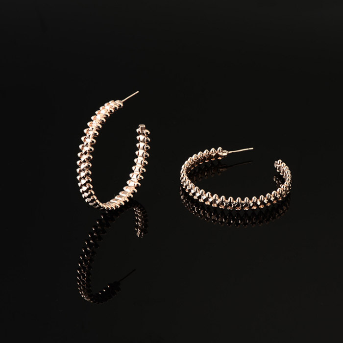 Gold textured hoop earrings showcasing the detailed design