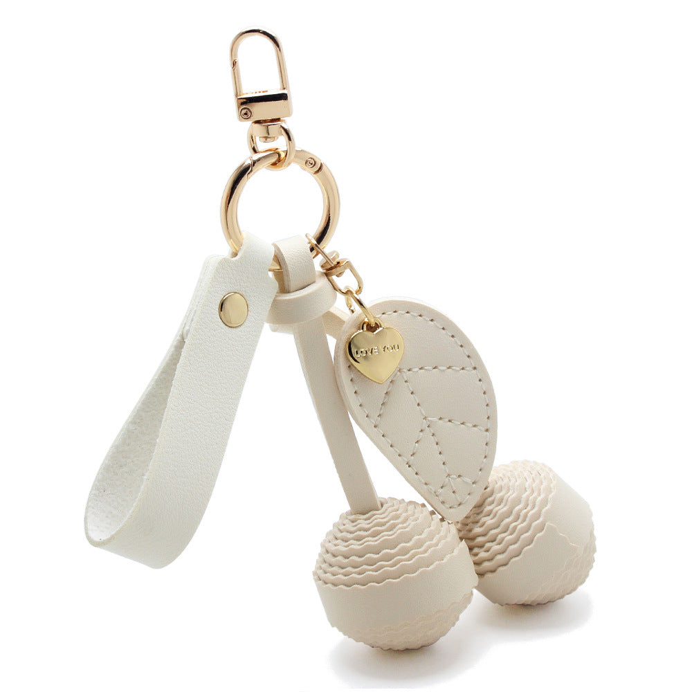 White PU leather cherry keychain with gold hardware