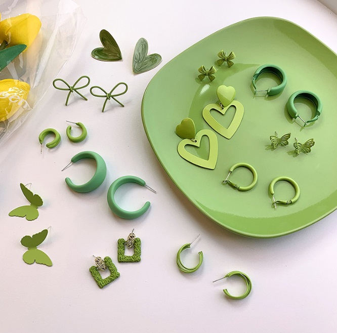 A diverse collection of trendy green earrings for summer.