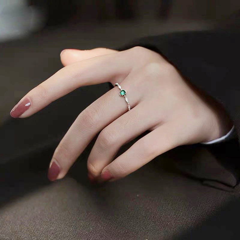 Model wearing the elegant 925 sterling silver ring with a green gemstone