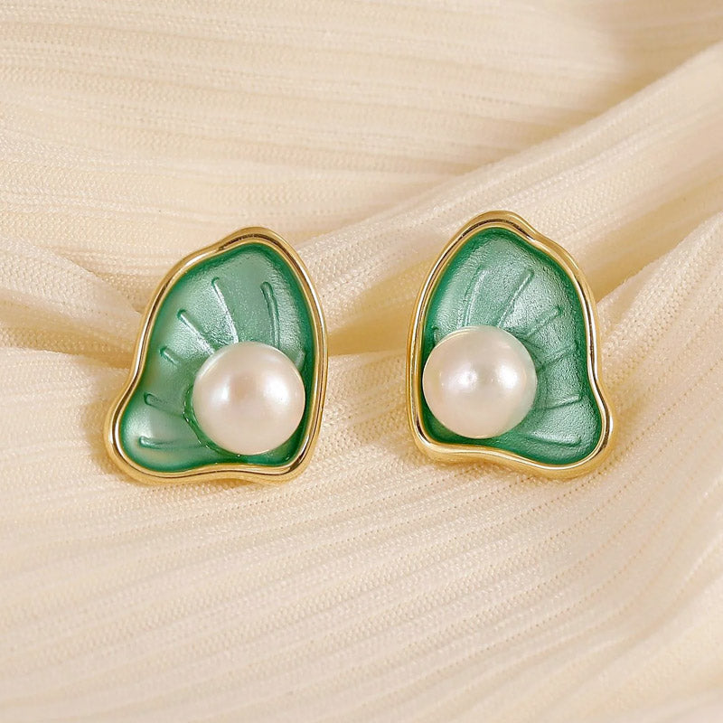 Close-up of the green enamel scallop pearl earring showcasing the detailed craftsmanship