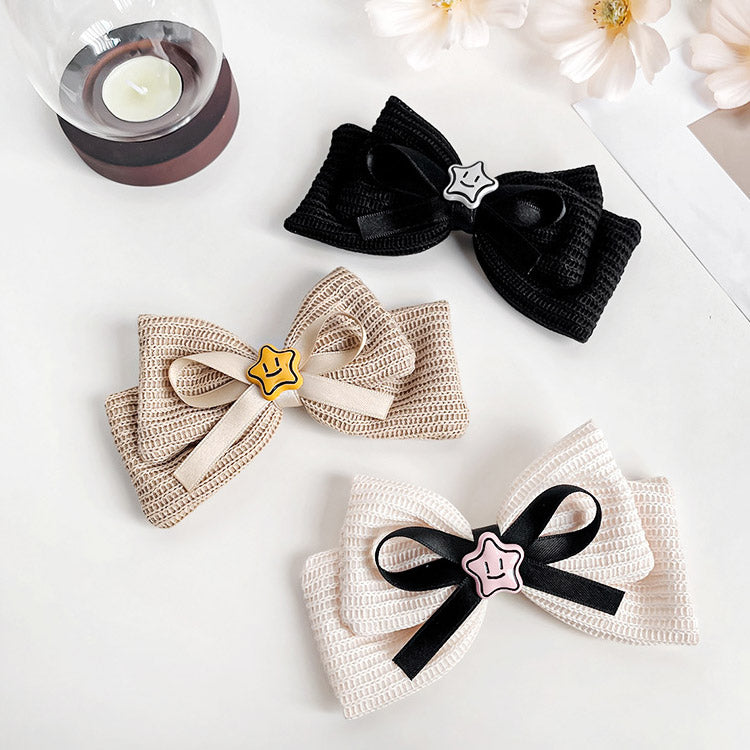 Three different colored hair bows with star decorations displayed