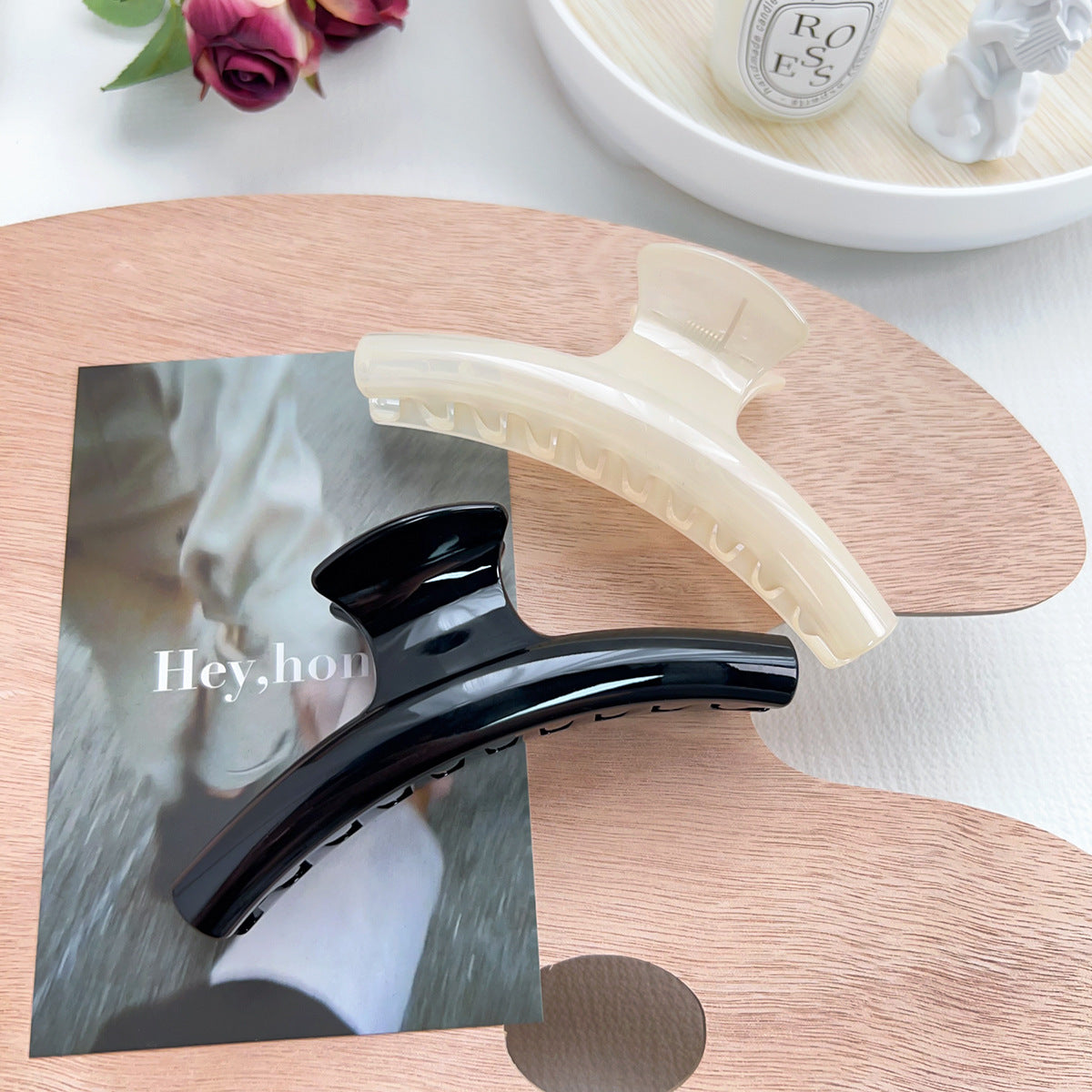 Stylish black and white arc-shaped hair clips showcased