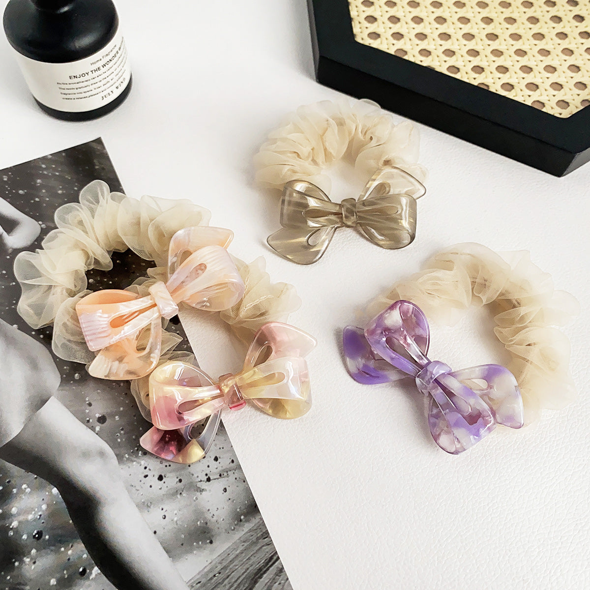 Various colors of acetate bow scrunchies displayed together