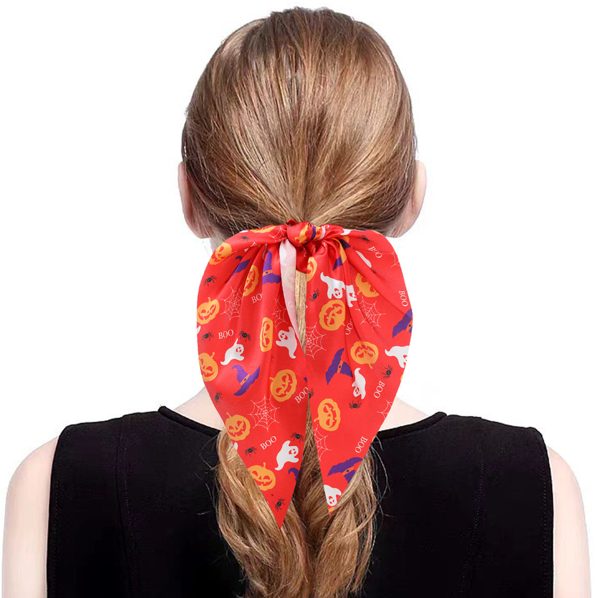 Model showcasing a red Halloween ribbon scrunchy in a ponytail