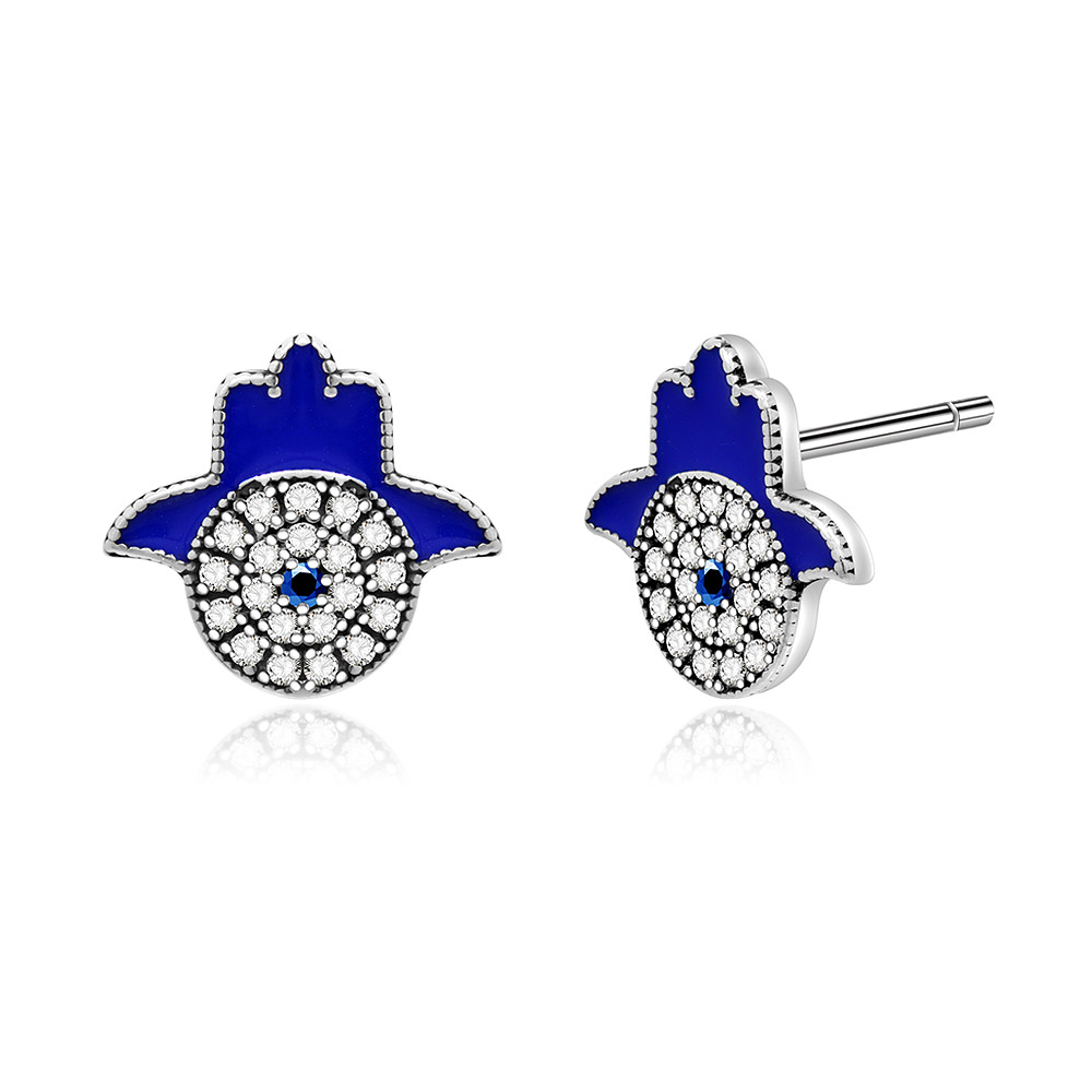 A detailed shot of the Hamsa hand earrings showing the blue and silver materials and gemstones.