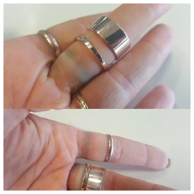 A woman's hand wearing multiple hypoallergenic stainless steel rings