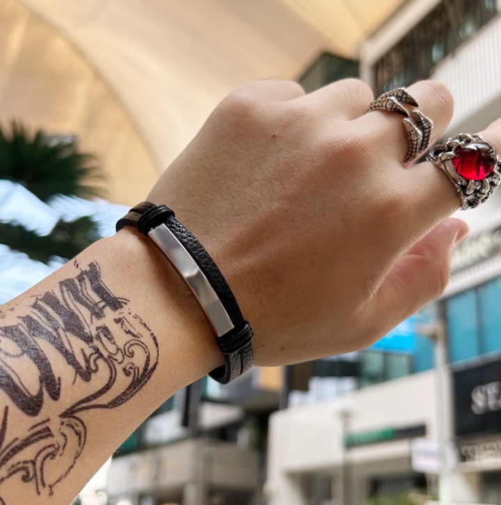 Man wearing the black PU leather and stainless steel bracelet