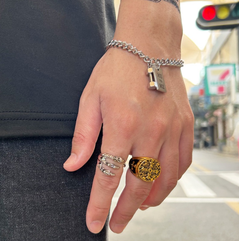 A man wearing the Nordic Viking Ring and a silver bracelet in an urban setting