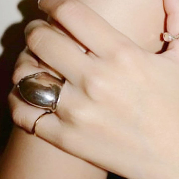 A model wearing the vintage brass rings to showcase their stylish appeal.
