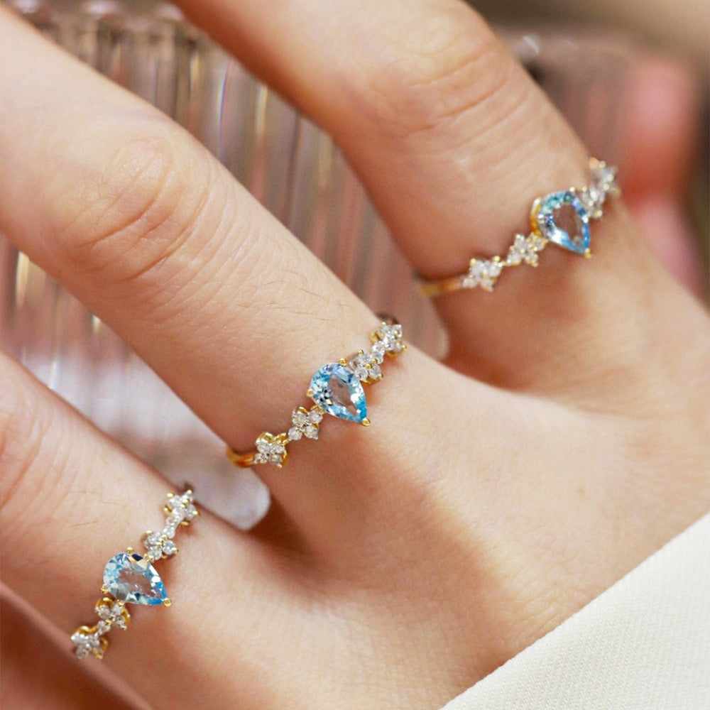 Model wearing the adjustable aquamarine pear-shaped ring