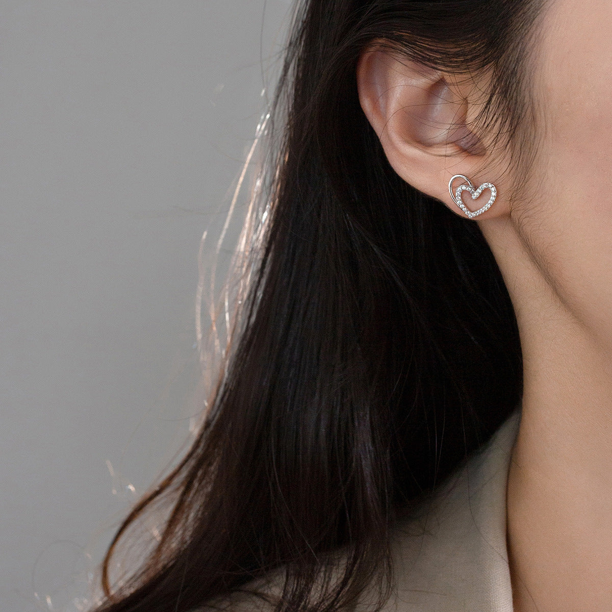 Model wearing the 925 silver hollow heart stud earring