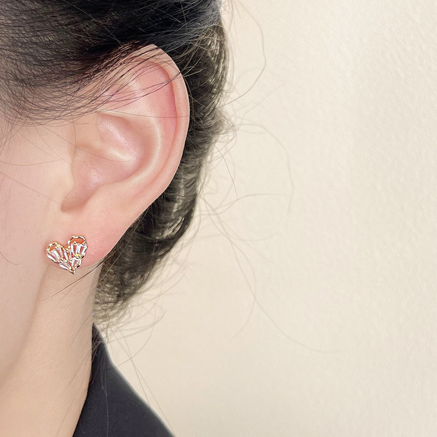 A model showcasing the elegant gold-plated heart-shaped zircon stud earring.