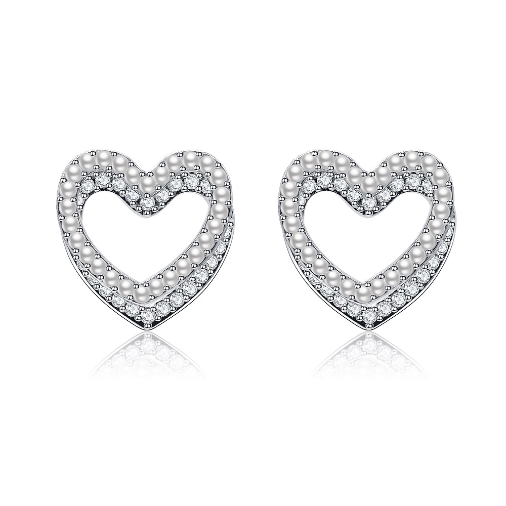 Detailed view of the Sweet Double Heart CZ Pearl Stud Earrings highlighting the silver finish