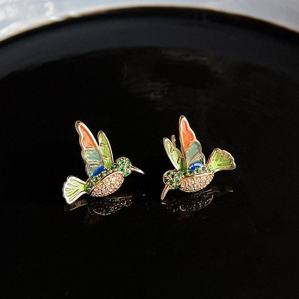 Detailed view of the gold-plated hummingbird earrings with colorful enamel and zircon stones