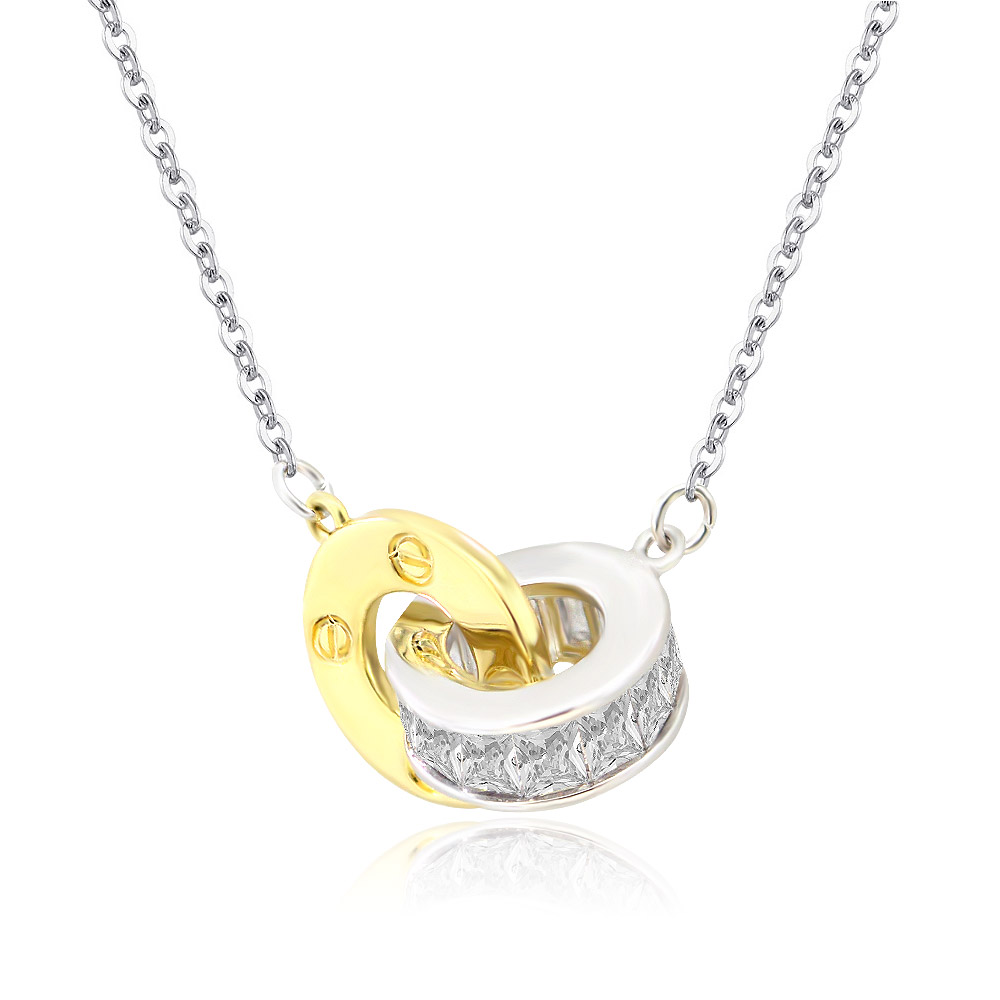 Detailed view of the interlocking gold and silver pendant with cubic zirconia