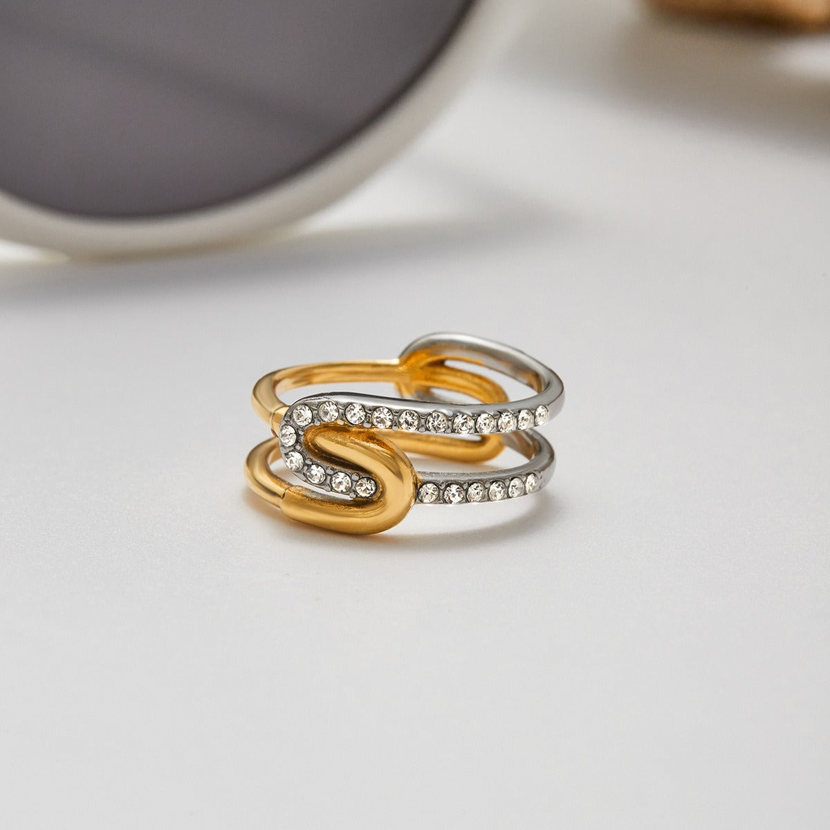 Intertwined gold and silver rhinestone rings on display
