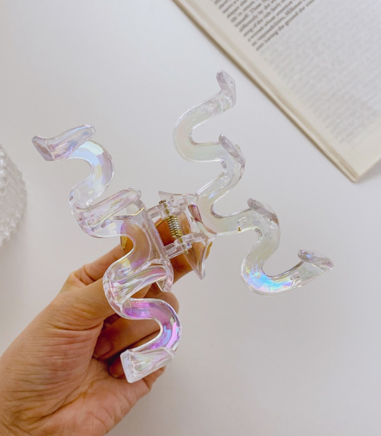 Detailed view of the iridescent spiral hair clip design