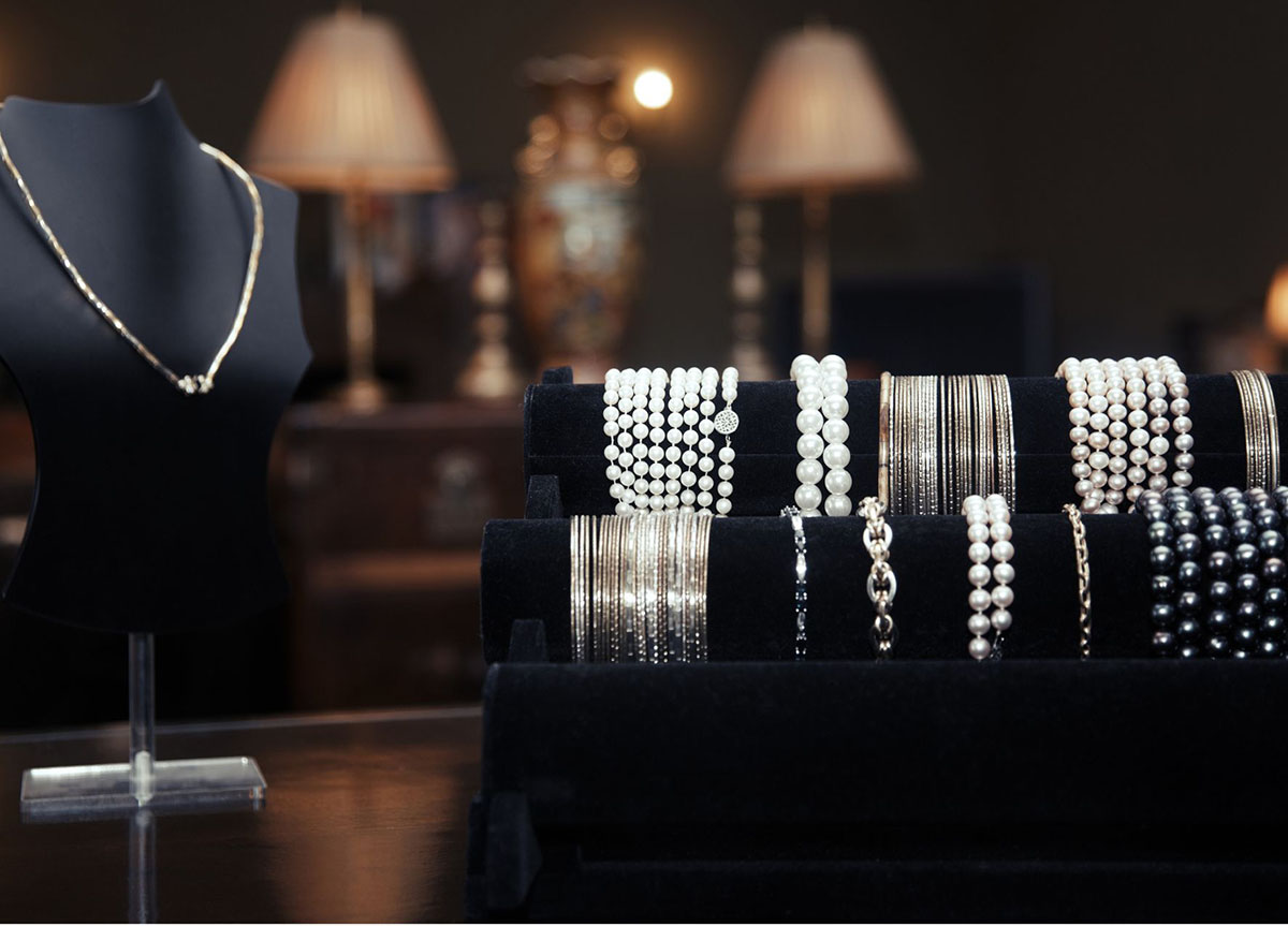 A display of custom bracelets and necklaces for small jewelry businesses.