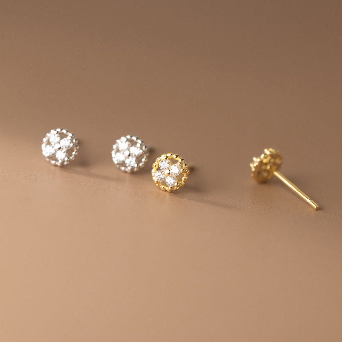 Gold and silver versions of the four-leaf clover stud earrings